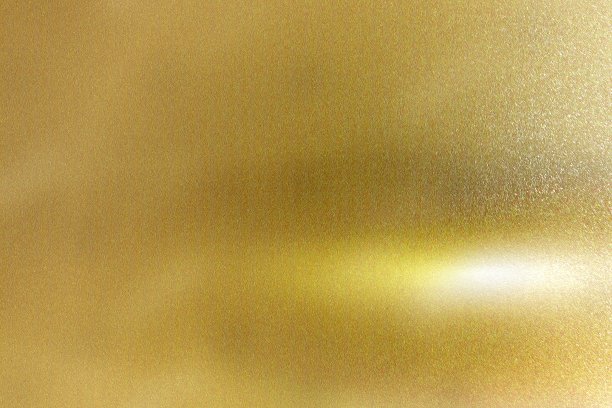 灯光照射在带有复制空间、抽象纹理背景的金箔金属板上图片下载
