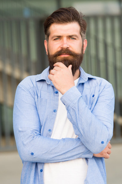 发型技巧。用胡须创造个人风格。时髦的胡子和小胡子城市背景的潮人。满脸胡须的男人。理发店,理发师。男性美图片下载