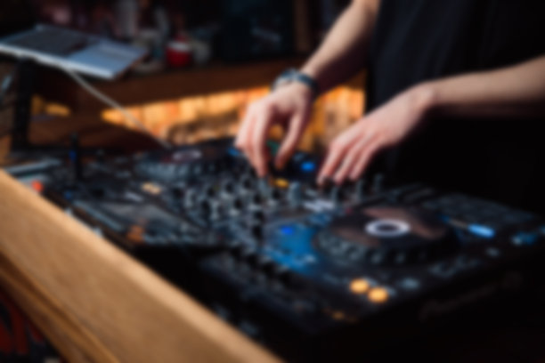 抽象模糊DJ手的遥控器。夜店，夜生活的概念图片下载