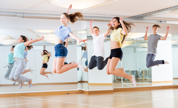 一群青少年在舞蹈锻炼中跳跃图片下载