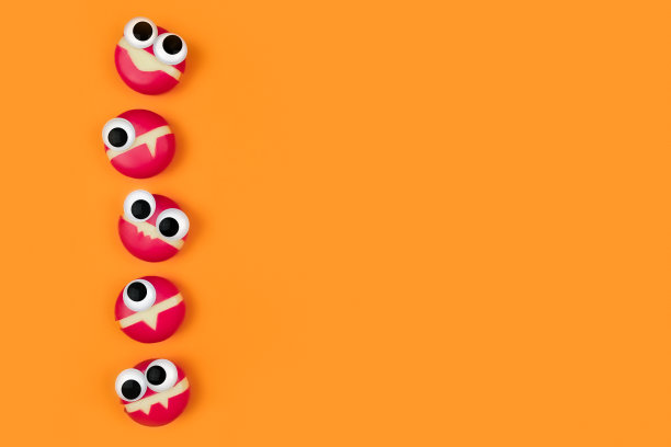 奶酪形状的小怪物，眼睛在橙色的背景。图片下载