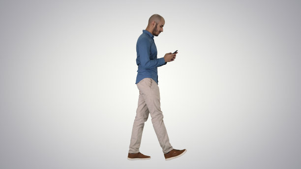 一个年轻人在渐变背景下用手机走路图片下载