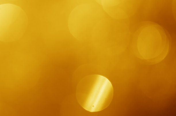 闪烁的灯光闪耀黄色金色华丽的散焦抽象背景闪亮。图片下载