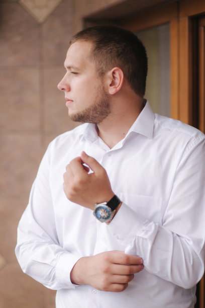 新郎在家的早晨。一个快乐的男人在他的婚礼上微笑着图片下载