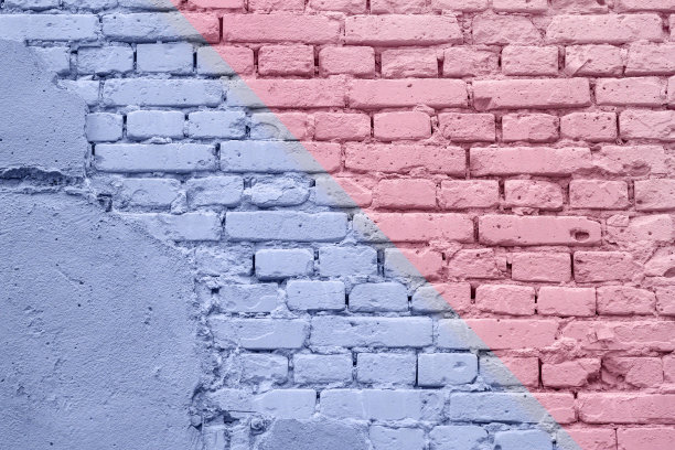 粗糙的灰泥砖墙与裂缝装饰抽象双色图纸几何涂料特写。涂鸦的细节。现代的背景。图片下载