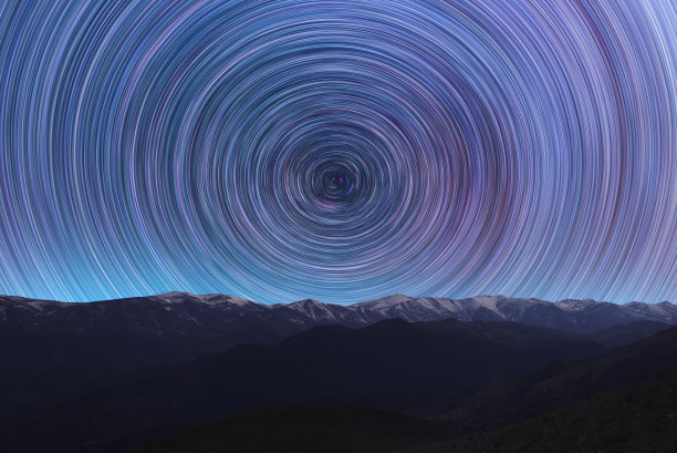 长曝光夜间景观。美丽的山脉和。五颜六色的星星在天空中划过。夜间延时摄影。图片下载