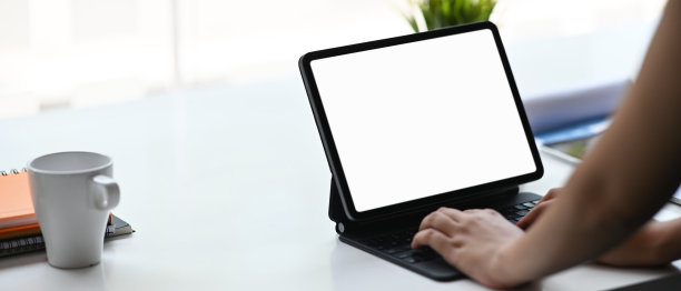 商业女性与电脑平板电脑在白色的桌子上工作的模型图像。模板为您的设计易于编辑。图片下载