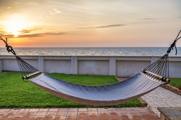 日落时分在海边的吊床上休息图片下载
