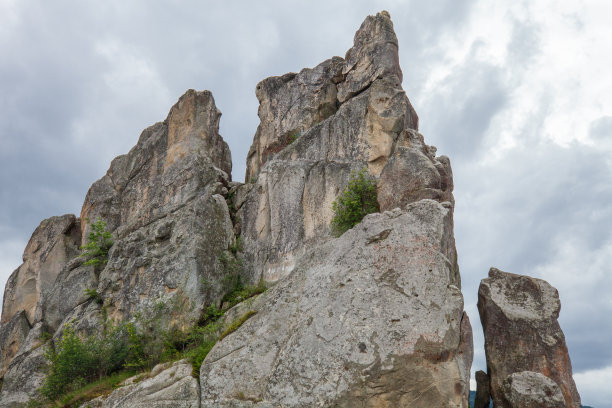 高耸的悬崖映衬着黑暗的暴风雨天空图片下载