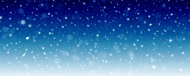 飘落的雪花映衬着蓝色的冬夜天空图片下载
