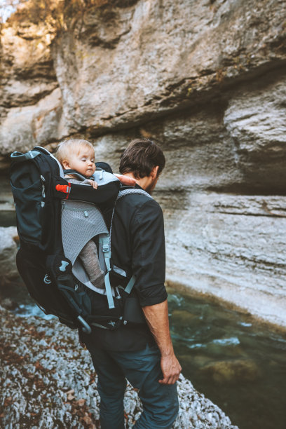 父亲徒步旅行与婴儿在背包承运人旅行冒险家庭生活方式户外度假探索岩石峡谷河流图片下载