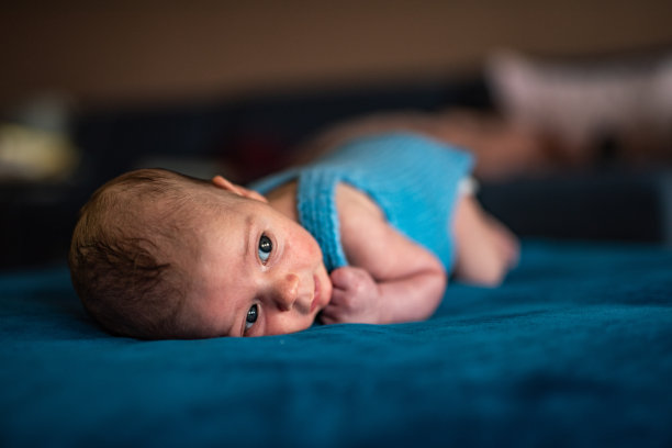 刚出生的男婴趴在地上享受着。图片下载