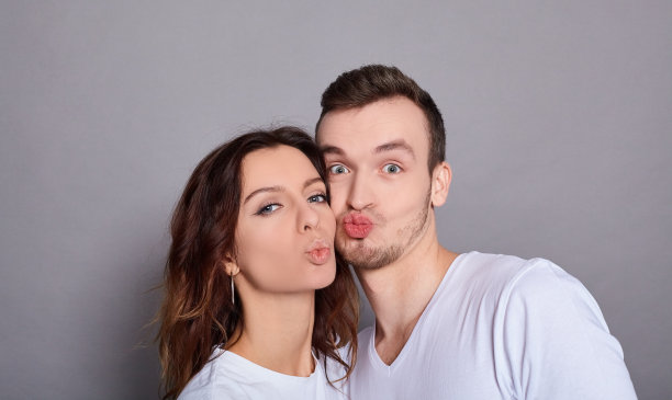 喜气洋洋的情侣在爱的拥抱和亲吻。图片下载