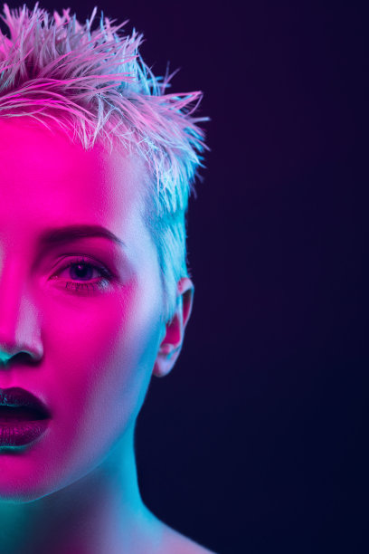 女时装模特的肖像在霓虹灯在黑暗的工作室背景。图片下载