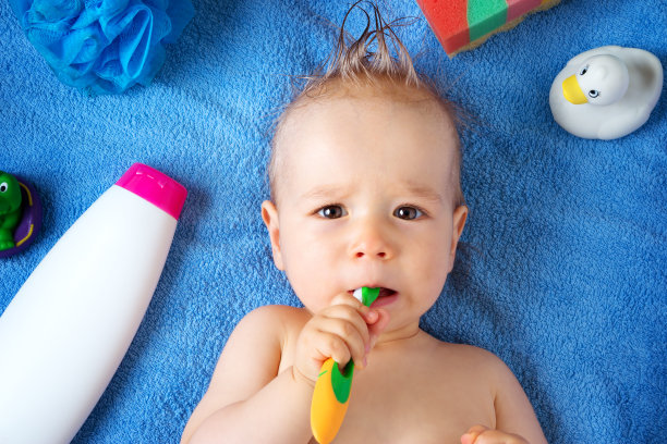 婴儿躺在毛巾和洗涤工具图片下载