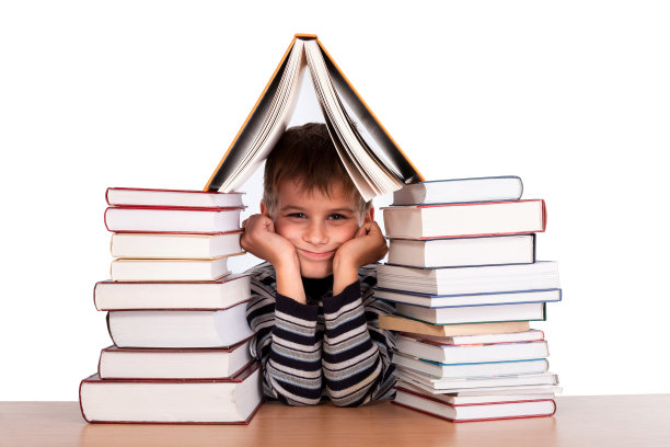 一个男孩和一堆书孤立在白色的背景上图片下载