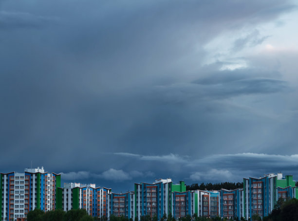 暴风雨天空背景下的现代新建筑。图片下载