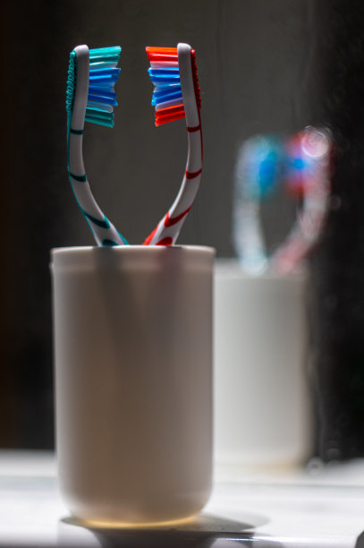 马桶架子上的玻璃杯里有两把牙刷。图片下载