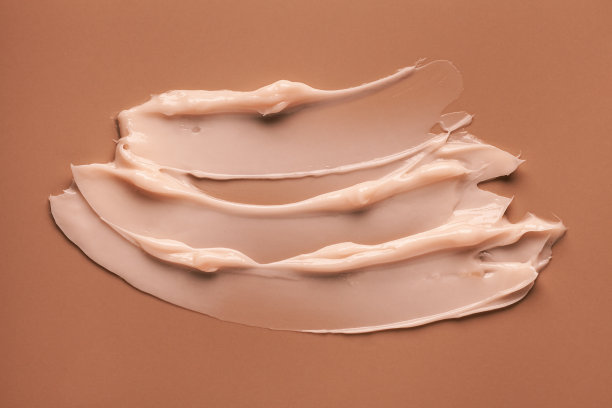 挤出光化妆品丝滑奶油牛奶质地焦糖米色背景图片下载