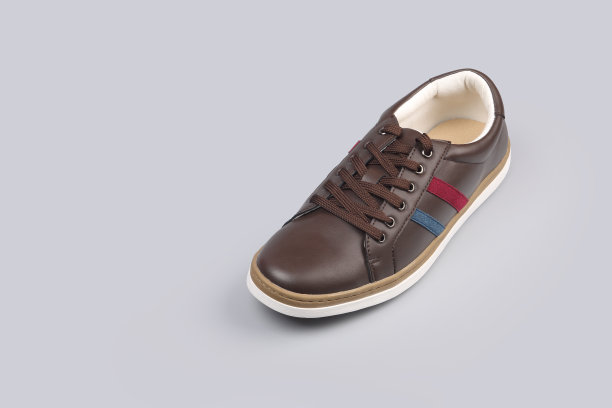 男人的皮革材料运动鞋在灰色的背景图片下载