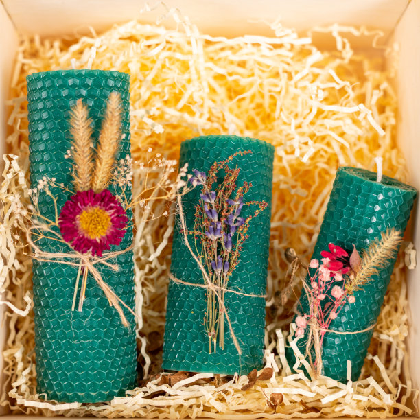 绿色蜂蜜蜡烛手工制作的天然蜡在礼品盒上的木丝背景。元素来自天然材料。圣诞节或新年的作文。照片的明信片。图片下载