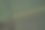 空荡的草地鸟瞰图，可以看到拖拉机留下的痕迹，中间有一圈芦苇，旁边有一条小沟渠图片下载