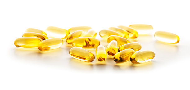 白色表面上的黄色药丸图片下载