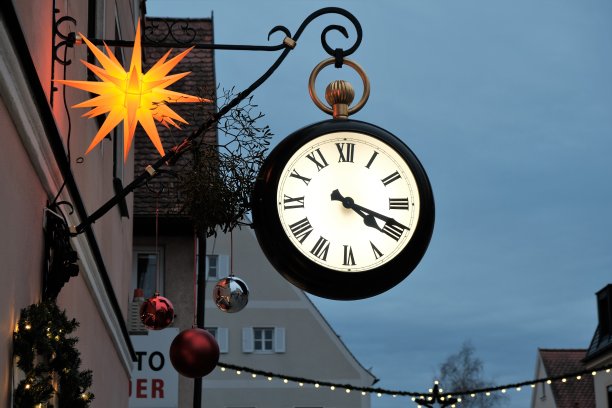 欧洲的圣诞节。Round clock and christmas street decor on festive christmas town模糊背景。圣诞节和新年在德国。圣诞节市场。冬天的圣诞节。街道节日图片下载