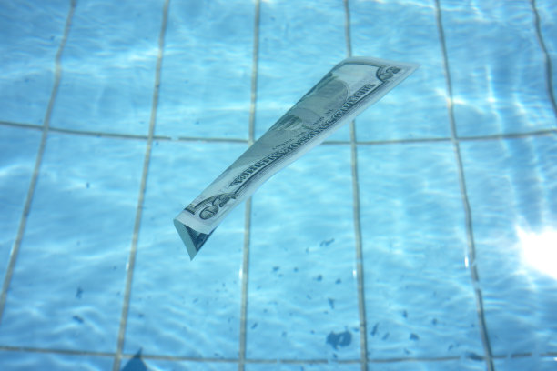 50美元的钞票在清澈的蓝色水面上游泳图片下载