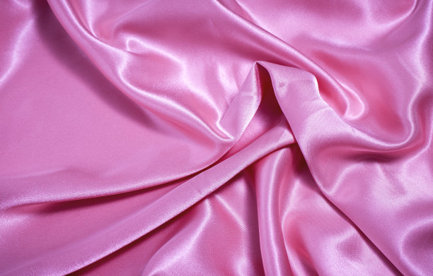 质地,背景。模板。丝绸面料粉红布波浪背景纹理。图片下载
