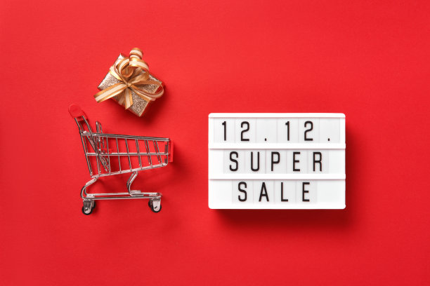 带有文字的灯箱，红色背景的金色礼盒和购物车。双12兆销售日平铺促销成分图片下载