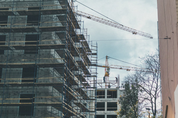 脚手架施工工人和起重机开发建设工程图片下载