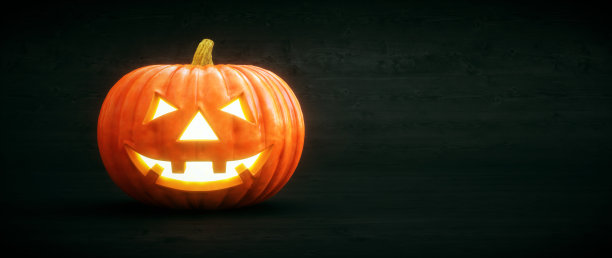 一个发光的南瓜头出现在深色的木制背景上图片下载