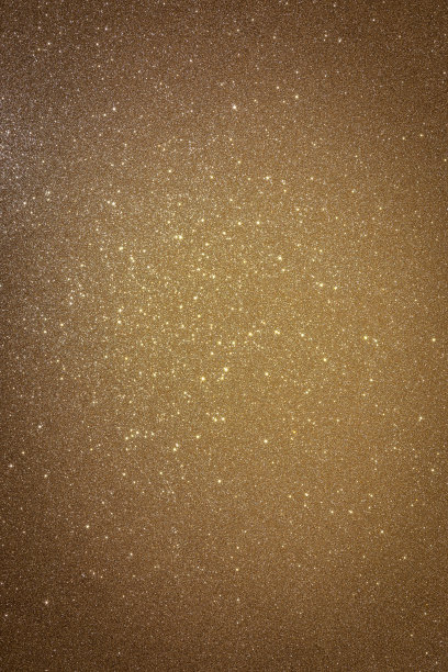金色背景，纹理和闪耀的星星在一个光点(垂直照片)图片下载