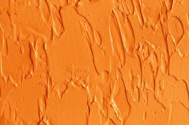 橙色南瓜面膜(面霜、姜黄身体磨砂膏)质地近距离，选择性聚焦。抽象的背景与画笔笔触。图片下载