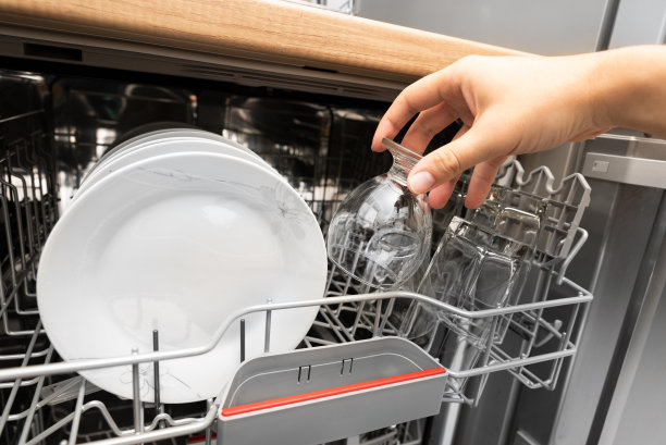 汉德从洗碗机里拿出一个干净的杯子图片下载