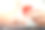 在特写镜头中，一个穿着白色毛衣的女人把笔记本电脑放在膝盖上，手里拿着一个红色的礼品盒。照片与照明。圣诞节、新年、节日的概念图片下载