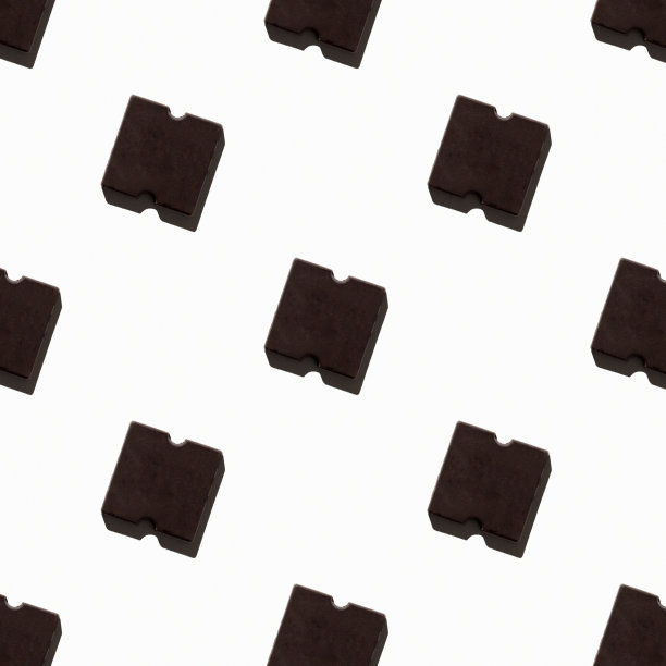 灯光背景下的小巧克力棒。无缝模式。的背景图片。艰难的影子。从上面看，地势平坦图片下载