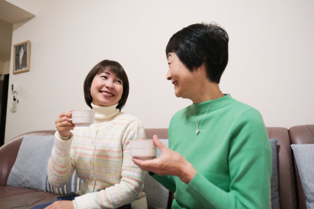 老年妇女和中年妇女一边喝茶一边聊天图片下载