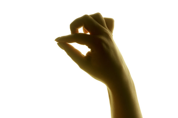 一个女人的手的剪影在明亮的白色背景。图片下载