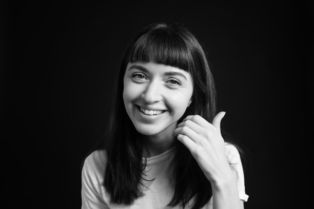 一个年轻女子的画室肖像，背景是纯黑色图片下载