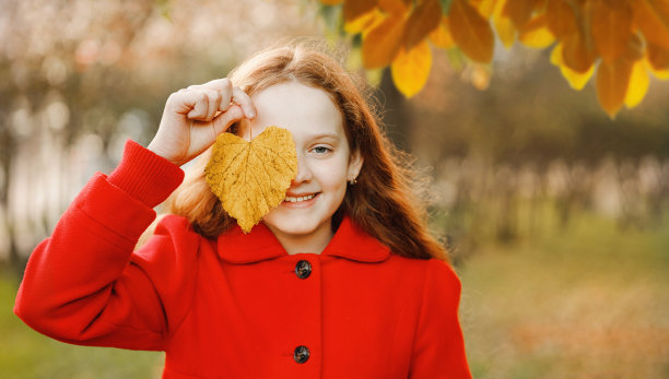 可爱的小女孩与秋天的树叶图片下载