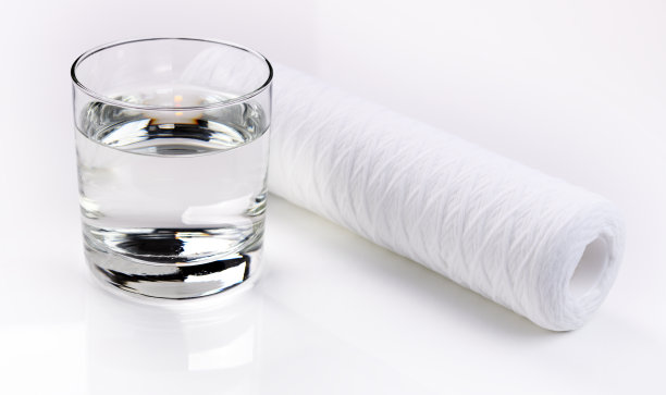 水过滤器。它旁边是一杯干净的水。白色背景，无隔离。特写镜头图片下载