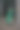 时尚的年轻女子在绿色大衣摆姿势在森林附近的树图片下载