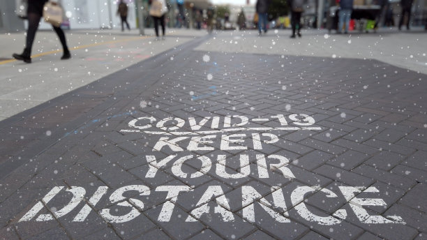 COVID - 19保持距离符号+粒子。图片下载