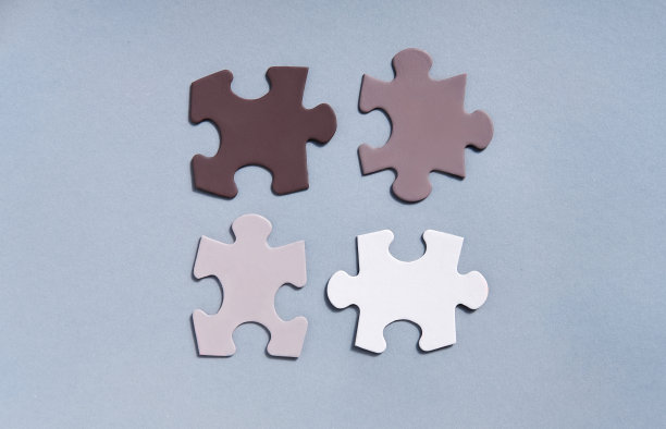彩色拼图拼图块在灰色背景上俯视图。团结起来结束种族主义的概念。联想和联系的象征，业务战略，团队支持和帮助的概念。图片下载