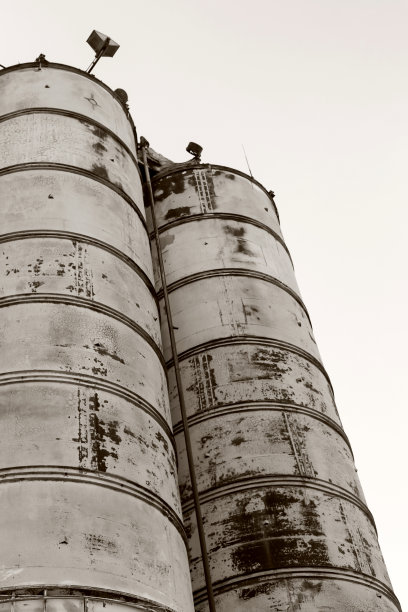 旧的，废弃的混凝土工厂有生锈的铁罐和金属结构。危机爆发，经济下滑，生产能力停止导致崩溃。全球灾难。老照片的效果图片下载