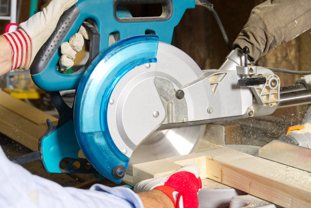 木匠用圆锯切割木条，他锯木条，建筑和家庭装修。木匠的工作概念图片下载
