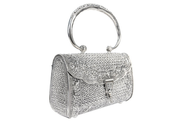 侧面的银色女人手袋与处理装饰藤蔓花孤立在白色的背景。银女士手袋装饰与藤本花锁隔离图片下载