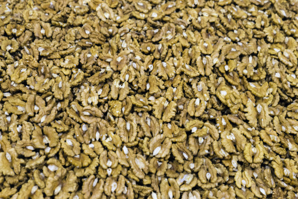 核桃。剥皮核桃背景纹理。有机坚果模式。螺母的设计样式。核桃股票照片。核桃的特写。食物壁纸。图片下载